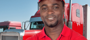 Student from American Driver Training Academy standing in front of a semi-truck