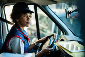 a woman behind the wheel of a big rig truck