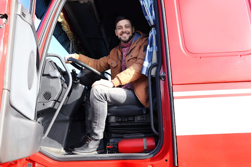 Truck driver sitting in the cab of his truck