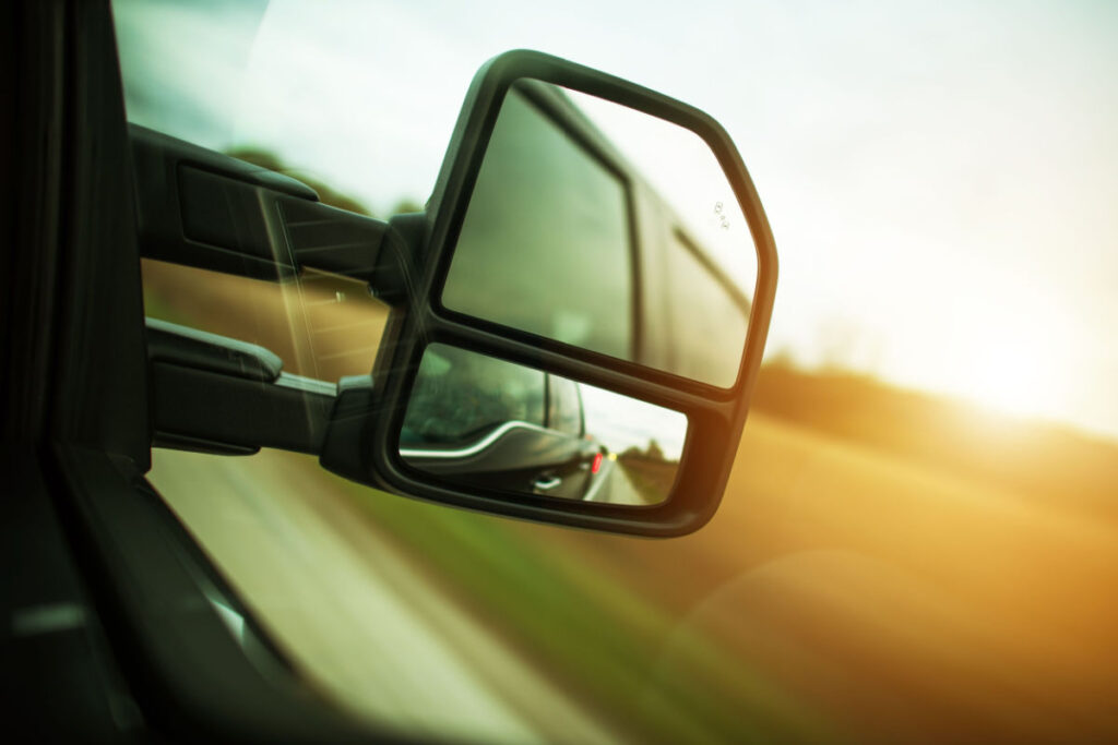 A close-up of a truck's side view mirror.